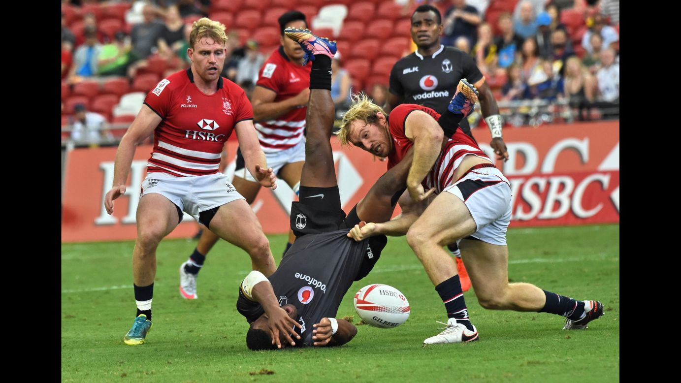 Toby Fenn of Hong Kong tackles Fiji's Amenoni Nasilasila during Day One of the Singapore Rugby Sevens tournament on Saturday, April 15.