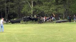 People examine an Army UH-60 helicopter from Fort Belvoir, Va., after it crashed at the Breton Bay Golf and Country Club after Monday, April 17, 2017, in Leonardtown, Md. (Rebecca Updegrave Cline via AP)
