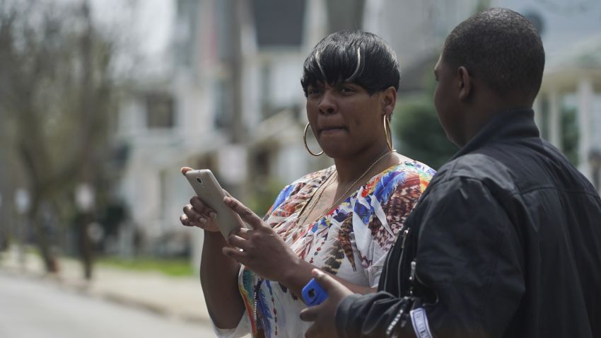 Alexis Lee, a childhood friend of Steve Stephens, speaks with a neighbor near Stephens' childhood home in Cleveland, Ohio, Monday, April 17, 2017. Authorities in Cleveland have expanded their manhunt nationwide for Stephens, a man suspected of gunning down a retiree and posting a video of the crime on Facebook. (AP Photo/Dake Kang)