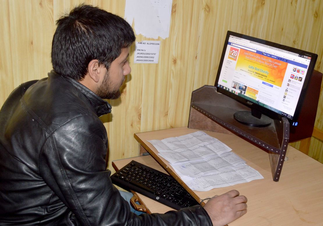 Nafees Ahmad, a Kashmiri youth browses the Lalla Ded Charity website to register as a volunteer. 