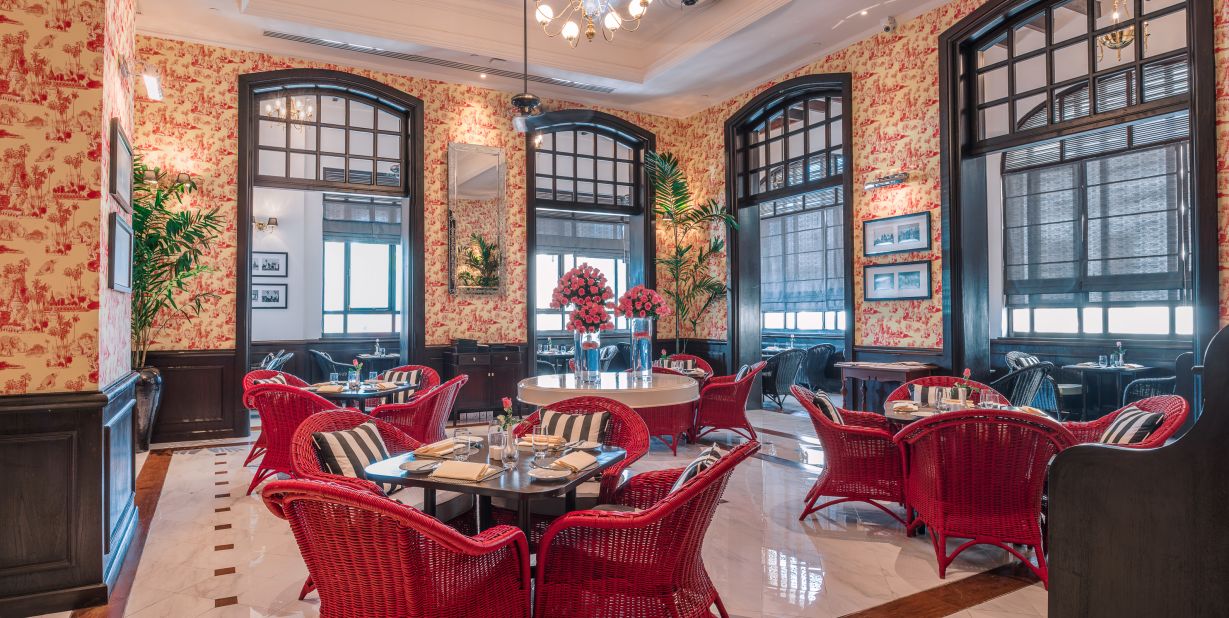 The Strand Café, a Yangon institution for afternoon tea, was given new furniture and wallpaper but its original teak-framed windows and vintage photos were retained.  <br />