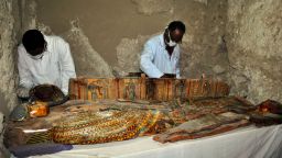 TOPSHOT - Members of an Egyptian archaeological team work on a wooden coffin discovered in a 3,500-year-old tomb in the Draa Abul Nagaa necropolis, near the southern Egyptian city of Luxor, on April 18, 2017.Egyptian archaeologists have discovered six mummies, colourful wooden coffins and more than 1,000 funerary statues in the 3,500-year-old tomb, the antiquities ministry said. / AFP PHOTO / STRINGER        (Photo credit should read STRINGER/AFP/Getty Images)