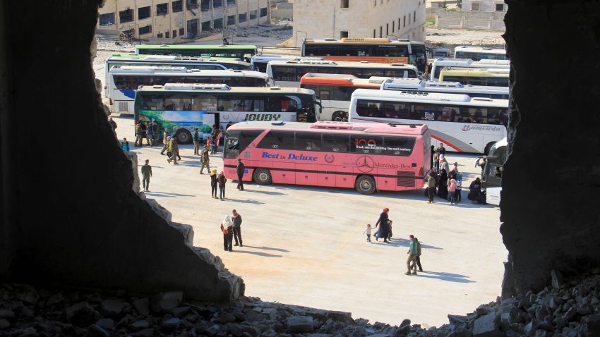 Syrians from the government-held towns of Fuaa and Kafraya, which have been under crippling siege for more than two years, reach with buses the edge of the rebel-held transit point of Rashidin outside government-held second city Aleppo, on April 19, 2017.
The evacuation of civilians and fighters from besieged Syrian towns resumed after a weekend bombing at a transit point killed 126 people, 68 of them children, an AFP correspondent reported. / AFP PHOTO / Omar haj kadourOMAR HAJ KADOUR/AFP/Getty Images