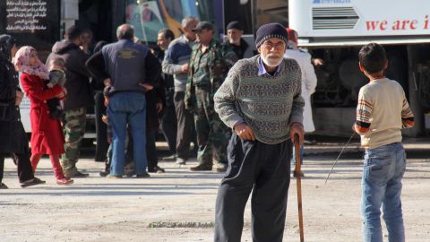 An elderly man waits to board the convoy.