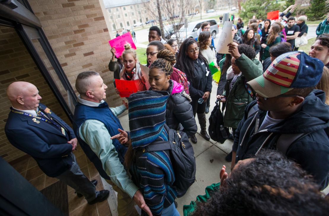 Police and officials block protesters from a University of Notre Dame hall where Charles Murray was speaking March 28.