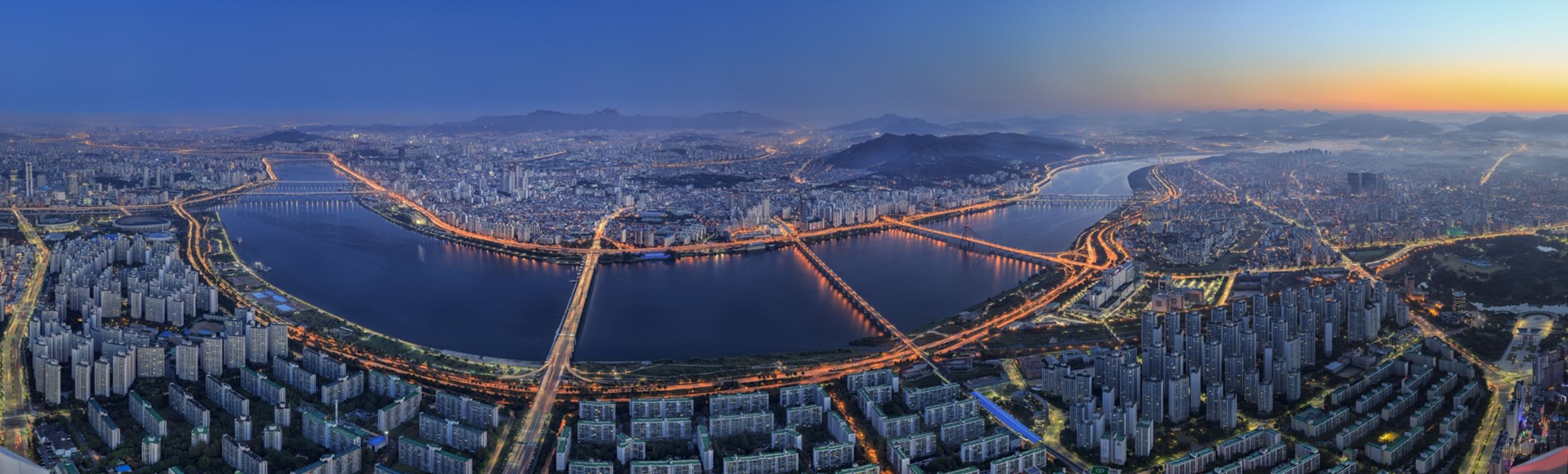 The expansive view overlooks the Seoul cityscape and Cheonggyecheon River, which flows through the heart of the city. 