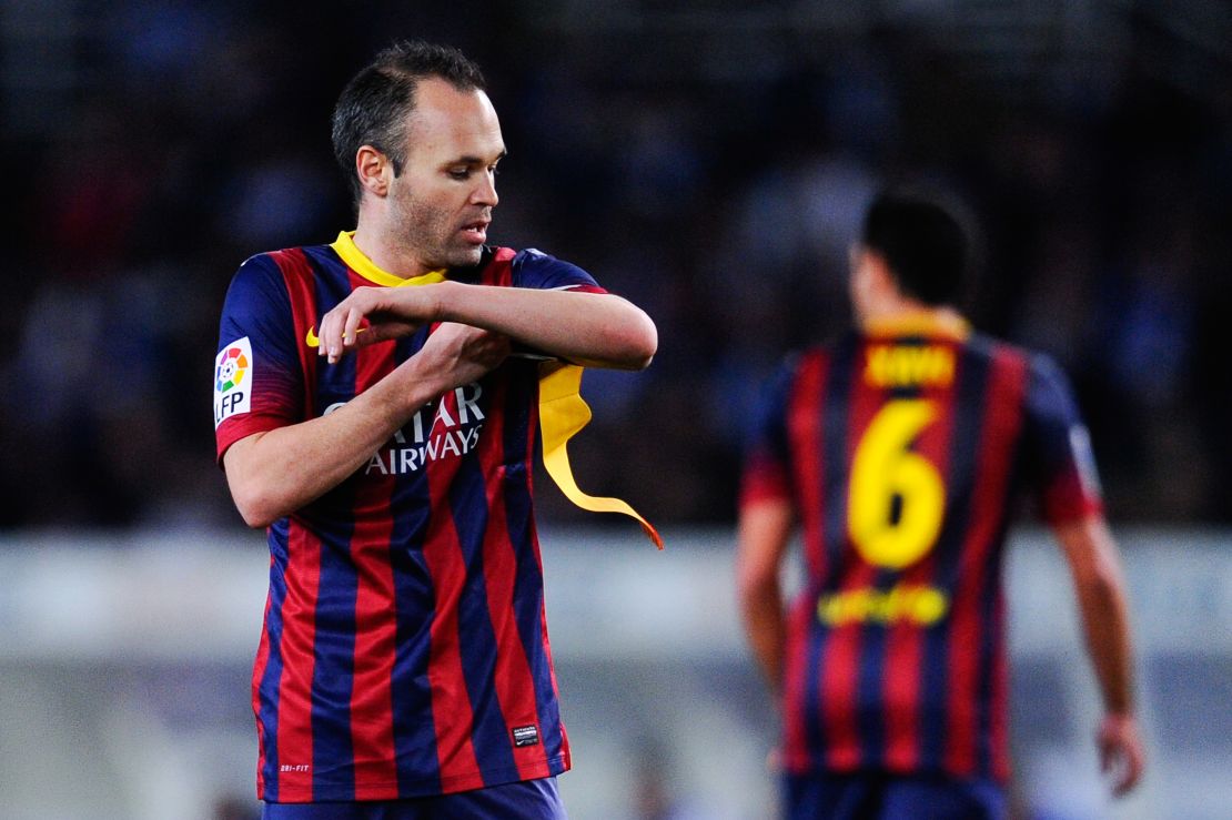 Andres Iniesta receives the Barcelona captain's armband from the departing Xavi Hernandez. 