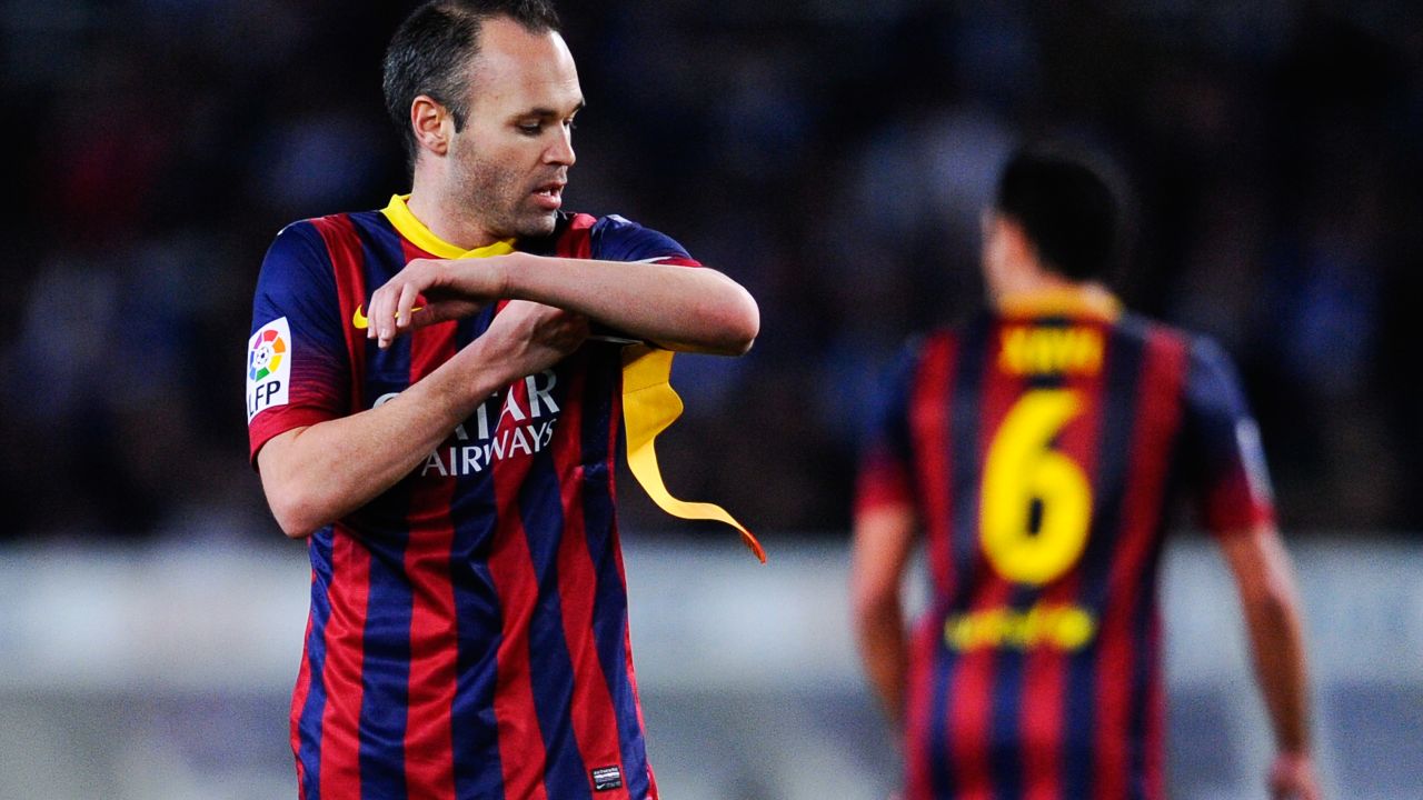 Andres Iniesta receives the Barcelona captain's armband from the departing Xavi Hernandez. 