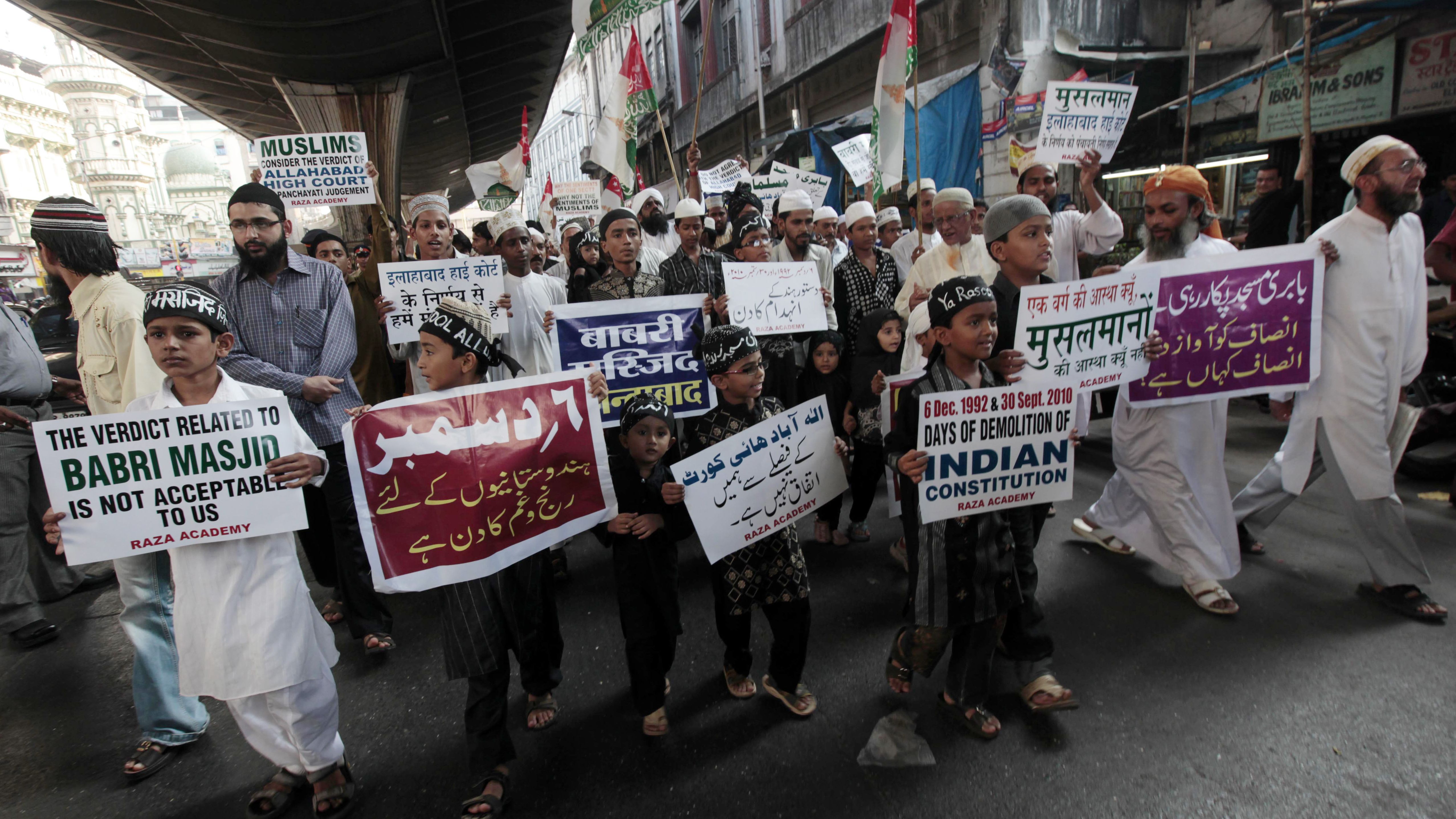 Muslim children in Mumbai  hold placards as they march with activists in December 2010 to mark the  anniversary of the demolition of the Babri Masjid.