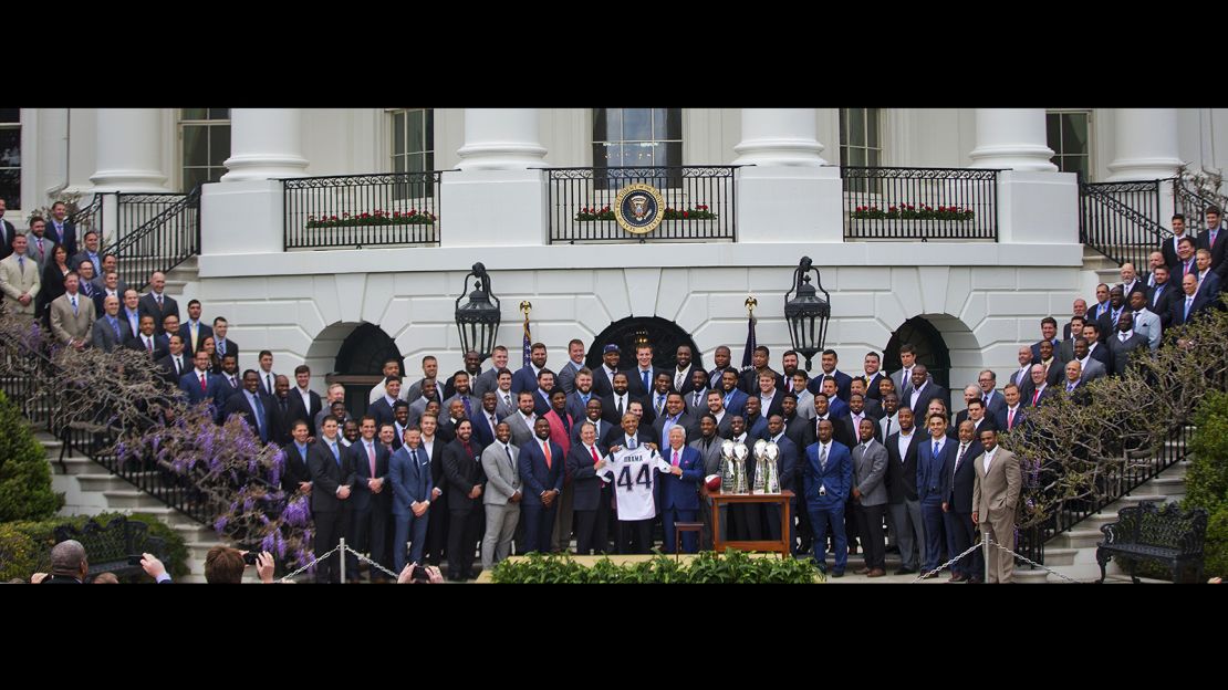 President Barack Obama holds a New England Patriots team football jersey, flanked by New England Patriots coach Bill Belichick, left, and team owner Robert Kraft, during a ceremony on the South Lawn of the White House in Washington, Thursday, April 23, 2015.