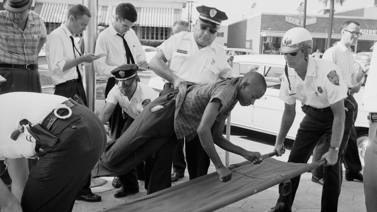 A protester being taken away by police at a civil rights demonstration.