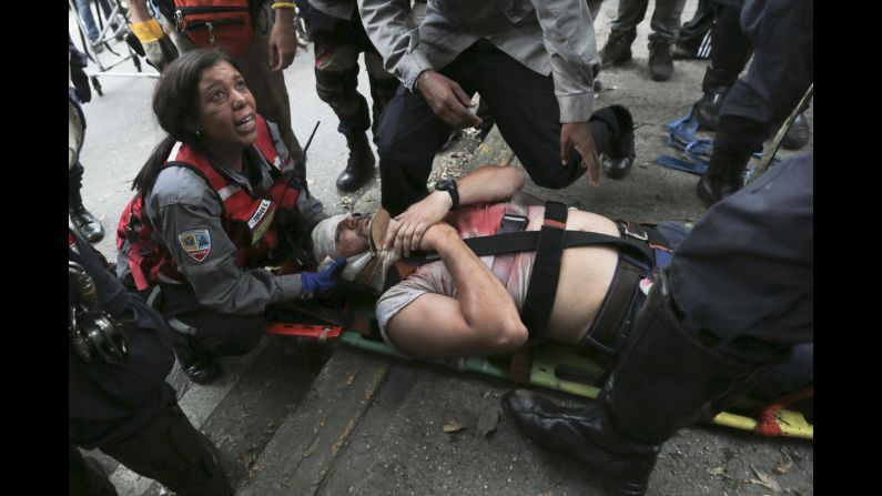 Rescue workers tend to a demonstrator hit by a tear gas canister during anti-government protests on April 19.