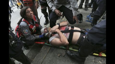 Rescue workers tend to a demonstrator hit by a tear gas canister during anti-government protests on April 19.