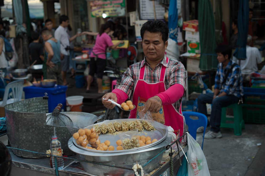 A street food vendor prepares take-away bags of food in the Thai capital Bangkok.