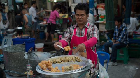 A street food vendor prepares take-away bags of food in the Thai capital Bangkok.