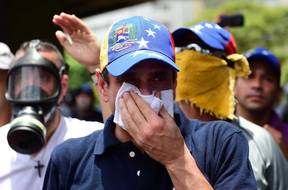 Opposition leader Henrique Capriles reacts to tear gas during a protest on April 19.