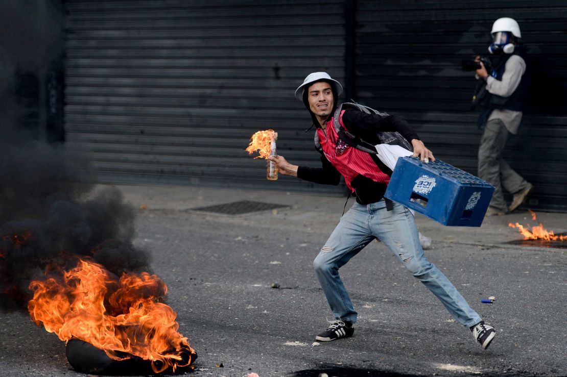 A protester prepares to throw a Molotov cocktail during a march Wednesday in Caracas.