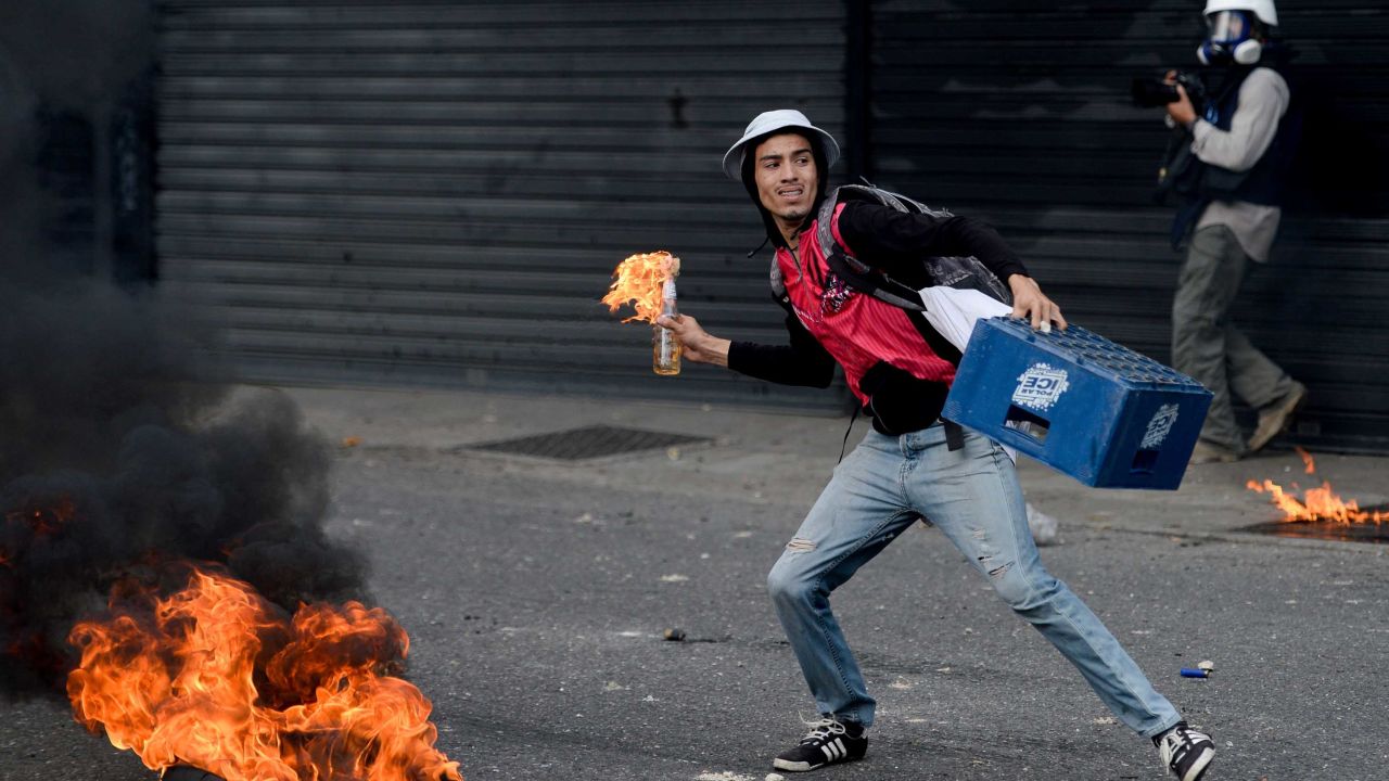 A protester prepares to throw a Molotov cocktail during a march Wednesday in Caracas.