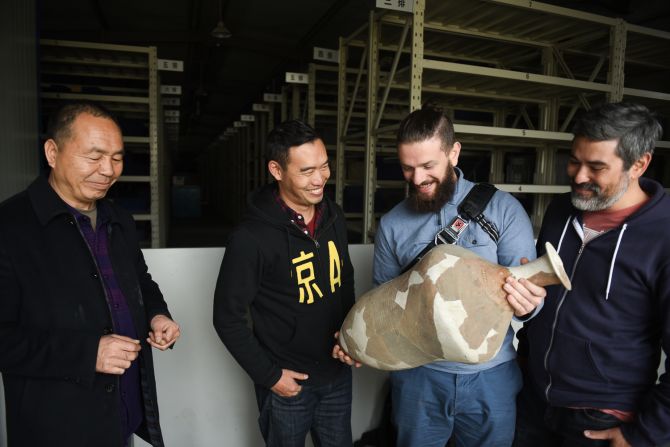 <strong>Ancient gear:</strong> Brewers examine one of the pots found at the Mijiaya site near Xi'an, in central China. From right to left: Alex Acker, Jing-A Brew Co; Laszlo Raphael of Moonzen; Kristian Li of Jing-A; and archeologist Xing Fu Lai, from the Shaanxi institute.
