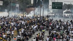 Demonstrators clash with the riot police during a protest against Venezuelan President Nicolas Maduro, in Caracas on April 20, 2017.
Venezuelan riot police fired tear gas Thursday at groups of protesters seeking to oust President Nicolas Maduro, who have vowed new mass marches after a day of deadly unrest. Police in western Caracas broke up scores of opposition protesters trying to join a larger march, though there was no immediate repeat of Wednesday's violent clashes, which left three people dead. / AFP PHOTO / CARLOS BECERRA        (Photo credit should read CARLOS BECERRA/AFP/Getty Images)