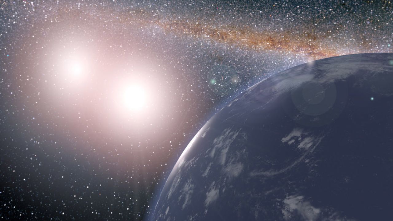 An artist's rendering of what this ocean world with two suns might look like.