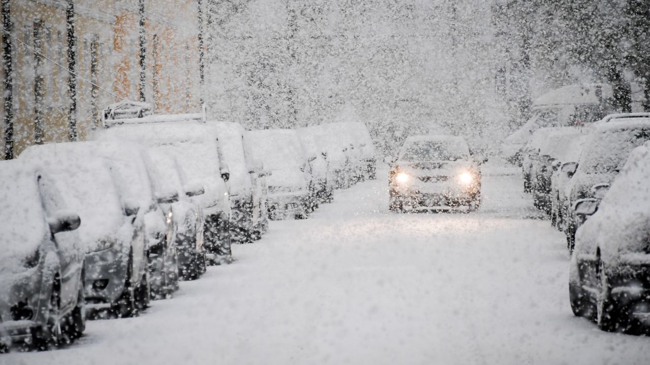 A car drives through snow in Munich, Germany, on Tuesday, April 18.