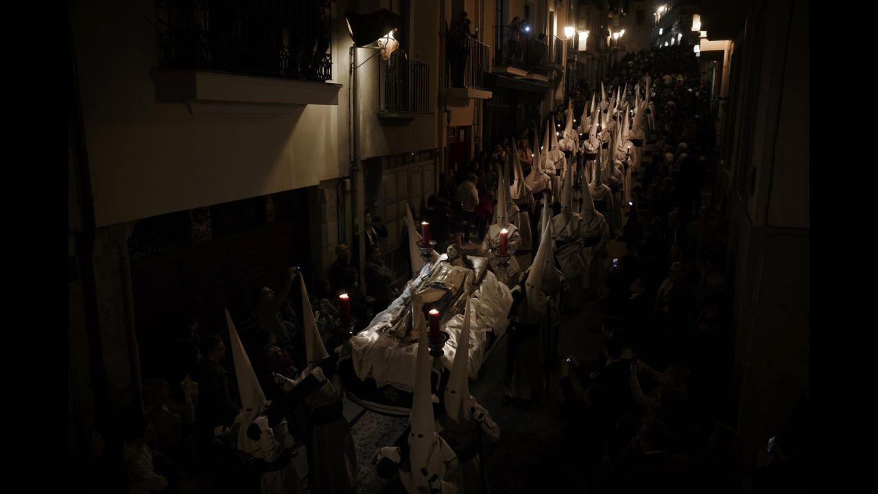 Penitents from the "Hermandad Penitencial de Jesus Yacente" brotherhood take part in a procession in Zamora, Spain, during the early hours of Friday, April 14. Hundreds of processions took place throughout the country during the Easter Holy Week.