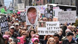 NEW YORK, NY - APRIL 15: People participate in a Tax Day protest on April 15, 2017 in New York City. Activists in cities across the nation are marching today to call on President Donald Trump to release his tax returns. (Photo by Stephanie Keith/Getty Images)