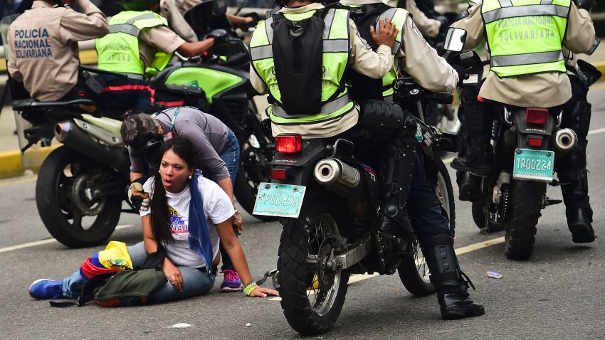 A demonstrator receives help during a protest against Venezuelan President Nicolas Maduro, in Caracas on April 20, 2017.
Venezuelan riot police fired tear gas Thursday at groups of protesters seeking to oust President Nicolas Maduro, who have vowed new mass marches after a day of deadly unrest. Police in western Caracas broke up scores of opposition protesters trying to join a larger march, though there was no immediate repeat of Wednesday's violent clashes, which left three people dead. / AFP PHOTO / RONALDO SCHEMIDT        (Photo credit should read RONALDO SCHEMIDT/AFP/Getty Images)