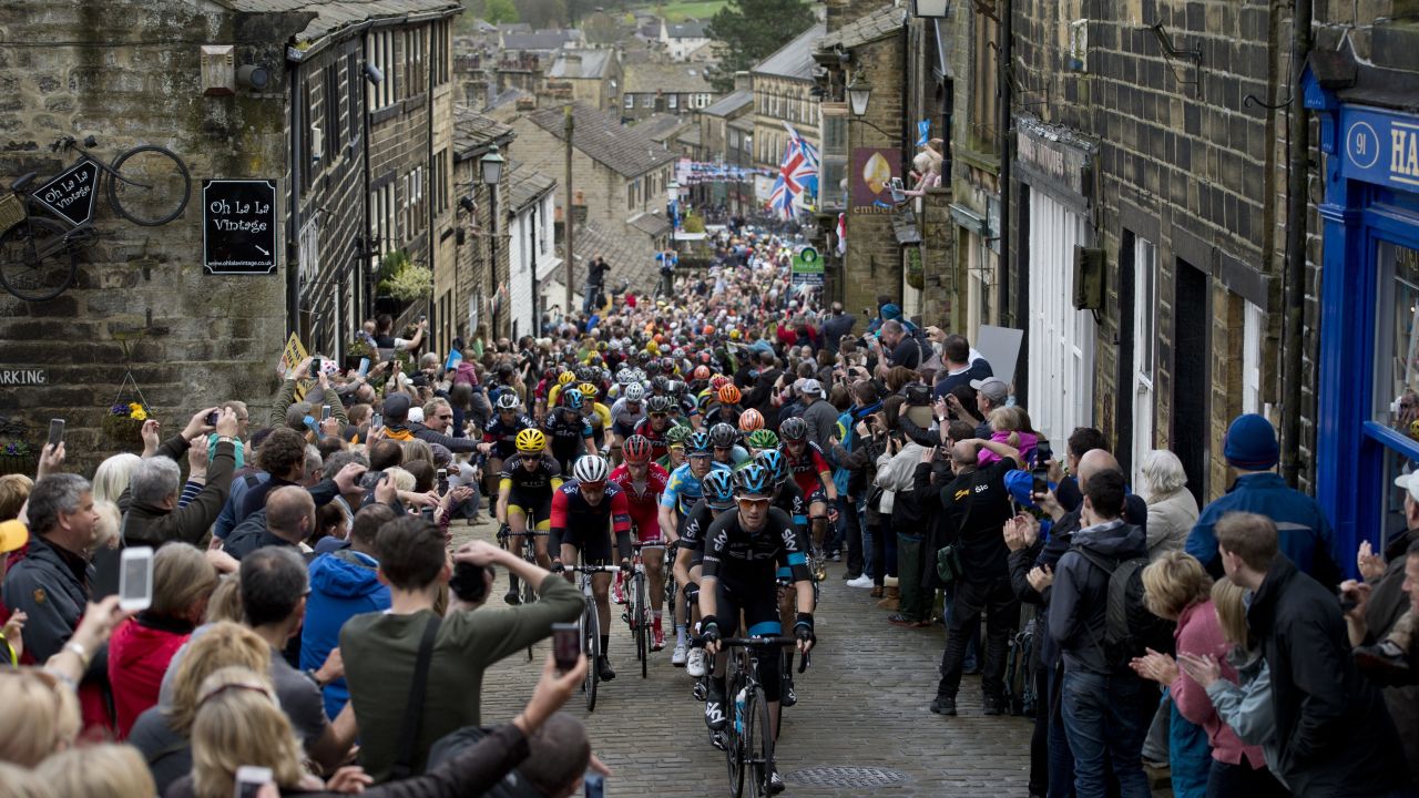 Cylists ride on a cobblestone street through the village of Haworth as they take part on the third and final day of the inaugural 'Tour de Yorkshire' in Haworth on May 3, 2015. 
 AFP PHOTO / OLI SCARFF        (Photo credit should read OLI SCARFF/AFP/Getty Images)
