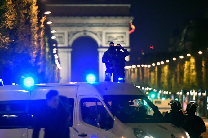 Police survey the Champs-Elysées as they work to secure the area.