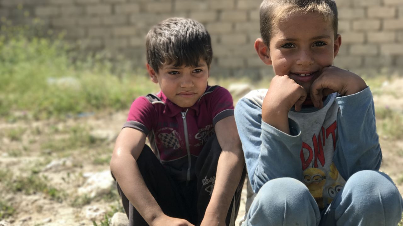 Children who fled the fighting in western Mosul waiting at a collection point for displaced families.