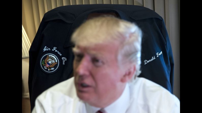 Trump sits in front of a jacket that was given to him by the crew of Air Force One on Thursday, January 26. It was his first trip aboard the plane and Marine One.