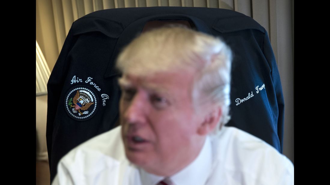 Trump sits in front of a jacket that was given to him by the crew of Air Force One on Thursday, January 26. It was his first trip aboard the plane and Marine One.