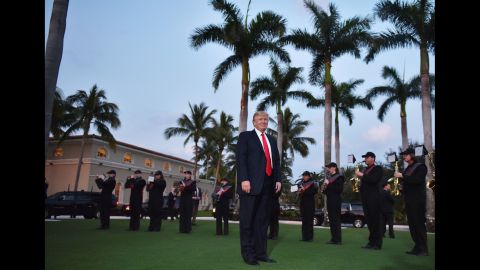 Trump listens to a high school marching band as he arrives at the Trump International Golf Club in West Palm Beach, Florida, on Sunday, February 5. The President and first lady attended a Super Bowl party there.