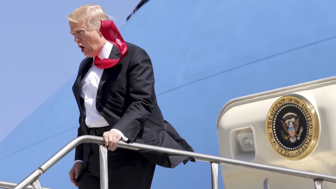 A strong wind blows Trump's tie as he arrives at Orlando International Airport on March 3. <a href="http://www.cnn.com/videos/politics/2017/02/02/trump-tie-too-long-moos-pkg-erin.cnn" target="_blank">CNN's Jeanne Moos reports on Trump's presidential neckwear: Long ties with Scotch tape on the back</a>