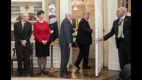 Vice President Mike Pence, third from left, tries to stop Trump as Trump <a href="http://www.cnn.com/2017/03/31/politics/donald-trump-executive-order-signing-walk-out/index.html" target="_blank">walks out of an executive order signing ceremony</a> on Friday, March 31. During the signing ceremony, White House pool reporters asked Trump questions about former national security adviser Michael Flynn, who has offered to testify on Russian involvement in the US election. The President ignored the questions and moved to another room to sign the two executive orders, which regarded trade policy.