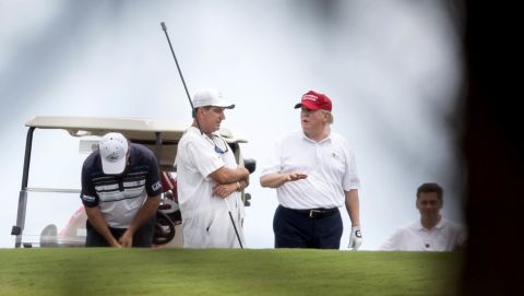Trump talks to a caddie during a round of golf in West Palm Beach, Florida, on Saturday, April 8. Trump frequently criticized President Obama for playing golf, <a href="http://www.cnn.com/2017/03/19/politics/trump-golf-weekends/" target="_blank">but he has been a frequent golfer</a> during his first few months in office.