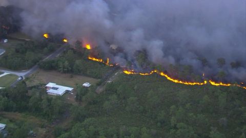 A brush fire burns in Polk County on Friday.