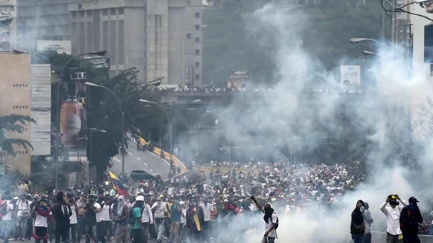 Demonstrators clash with the riot police during a protest against Venezuelan President Nicolas Maduro, in Caracas on April 20, 2017.
Venezuelan riot police fired tear gas Thursday at groups of protesters seeking to oust President Nicolas Maduro, who have vowed new mass marches after a day of deadly unrest. Police in western Caracas broke up scores of opposition protesters trying to join a larger march, though there was no immediate repeat of Wednesday's violent clashes, which left three people dead. / AFP PHOTO / JUAN BARRETO        (Photo credit should read JUAN BARRETO/AFP/Getty Images)