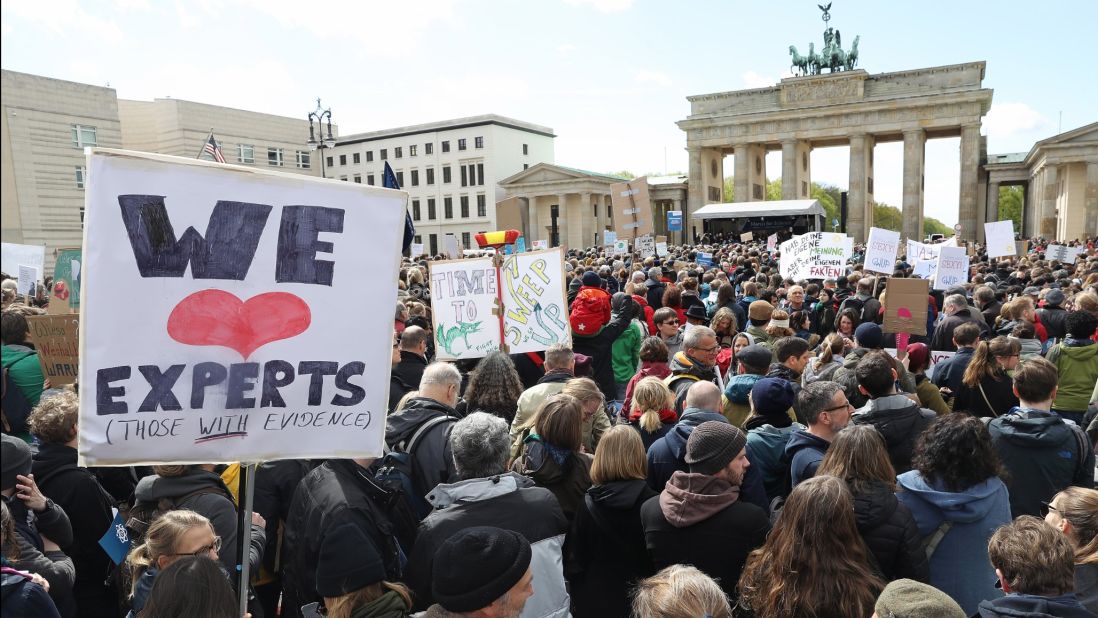 Marchers gathered in front of the Brandenburg Gate in Berlin. Similar marches drew people in more than 500 cities around the world.