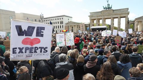Crowds converge Saturday in front of the Brandenburg Gate in Berlin support of scientific research.