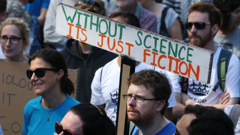 People stand together in Martin Place, in Sydney, Australia,for the city's international March for Science.