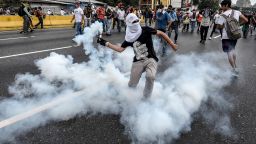 TOPSHOT - Demonstrators clash with the riot police during a protest against Venezuelan President Nicolas Maduro, in Caracas on April 20, 2017.
Venezuelan riot police fired tear gas Thursday at groups of protesters seeking to oust President Nicolas Maduro, who have vowed new mass marches after a day of deadly unrest. Police in western Caracas broke up scores of opposition protesters trying to join a larger march, though there was no immediate repeat of Wednesday's violent clashes, which left three people dead. / AFP PHOTO / JUAN BARRETO        (Photo credit should read JUAN BARRETO/AFP/Getty Images)