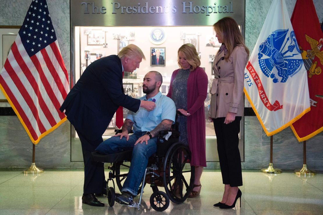 President Donald Trump awards the purple heart to Sergeant First Class Alvaro Barrientos.