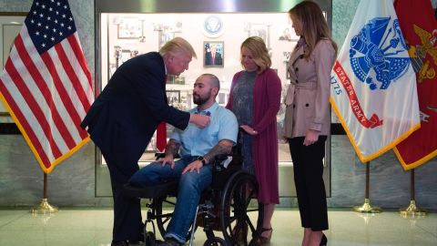 President Donald Trump awards the purple heart to Sergeant First Class Alvaro Barrientos.