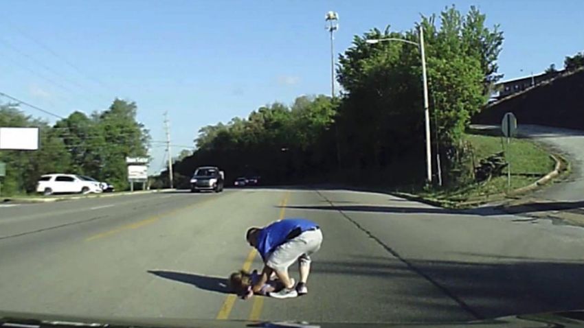 firefighter pulls girl out of road