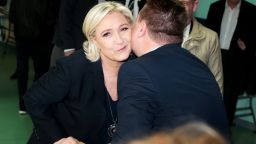 French presidential election candidate for the far-right Front National (FN - National Front) party Marine Le Pen kisses an electoral official at a polling station in Henin-Beaumont, north-western France, on April 23, 2017, during the first round of the Presidential election. / AFP PHOTO / joel SAGET        (Photo credit should read JOEL SAGET/AFP/Getty Images)