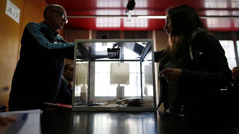 A woman casts her vote at a polling station in Paris.