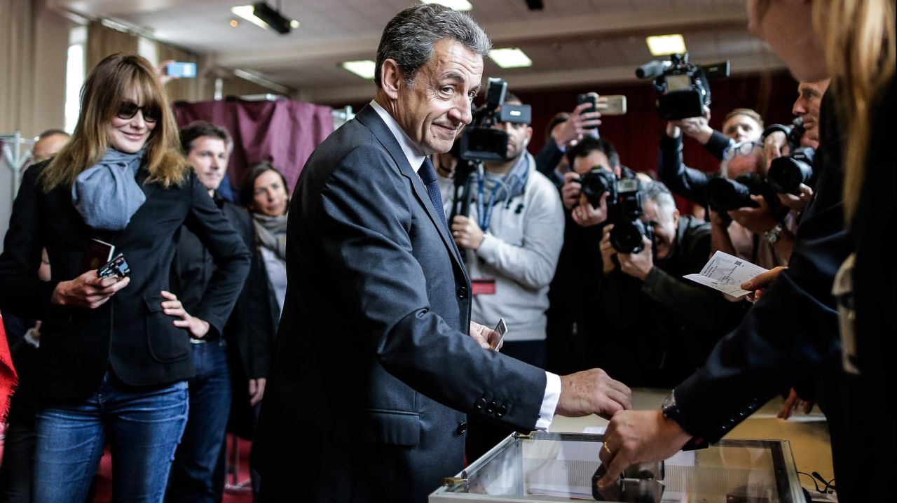 Former French president Nicolas Sarkozy and his wife, Carla Bruni Sarkozy, vote at a polling station in Paris.